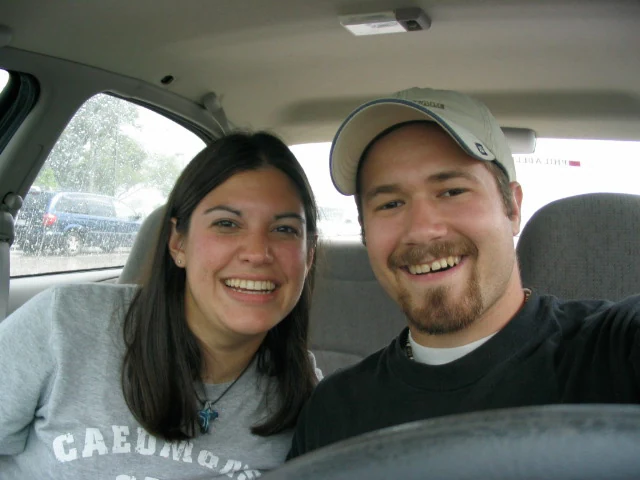 A young Tim and Dana smiling together in a car at the beginning of their relationship